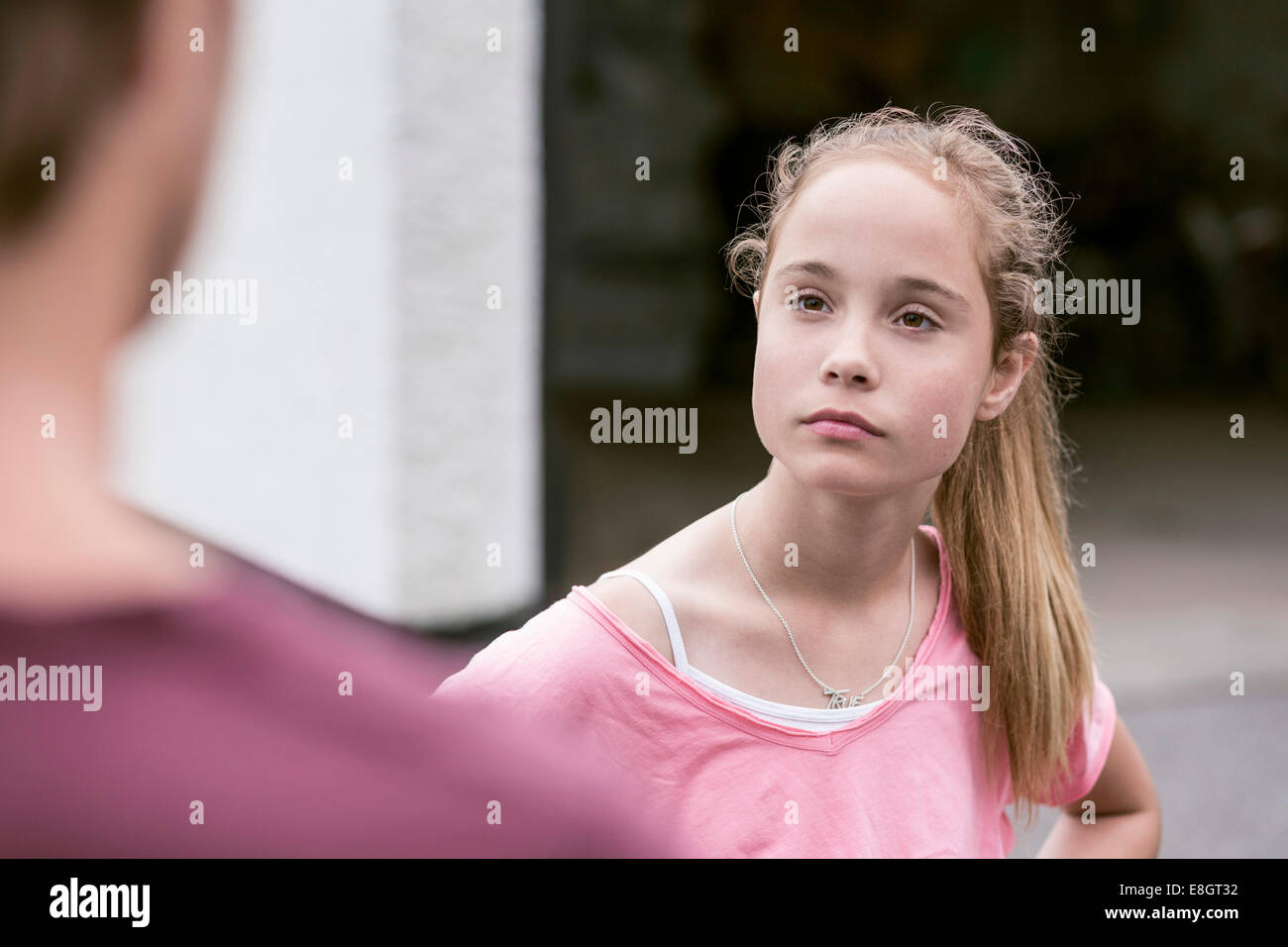 Angry girl looking at father outdoors Stock Photo