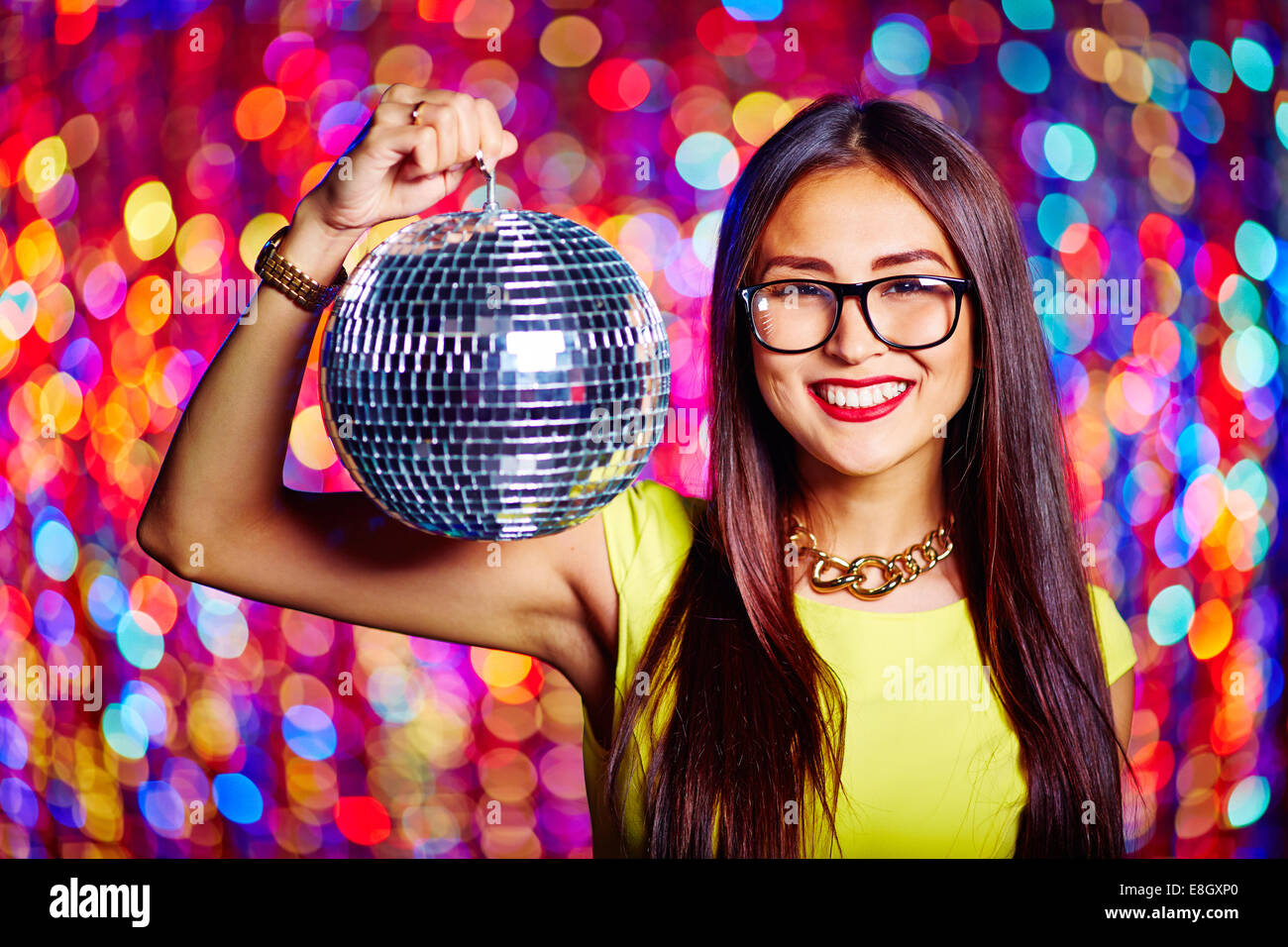 Portrait of a girl in glasses holding disco ball Stock Photo