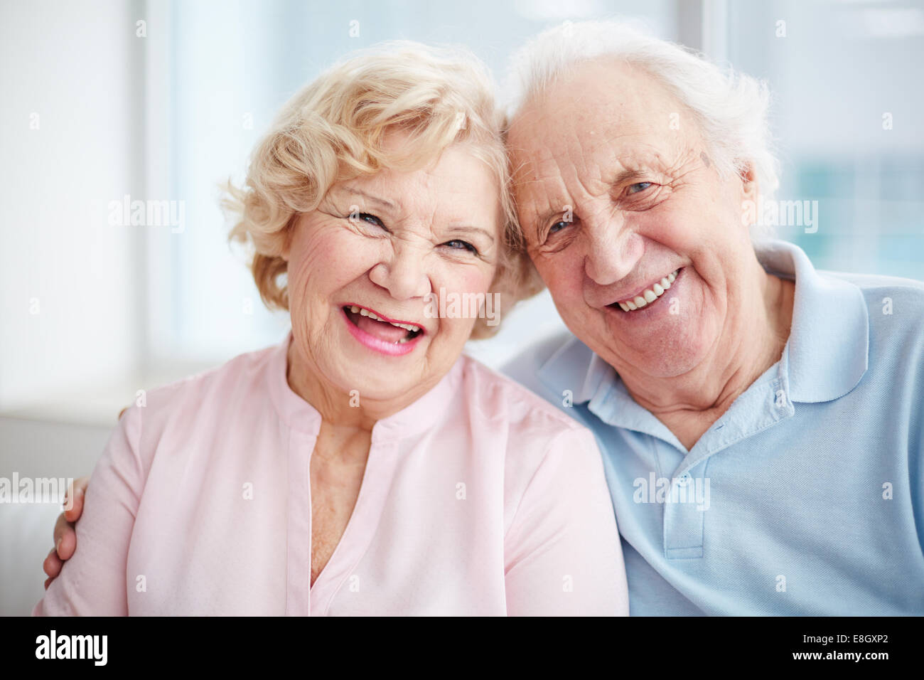 Portrait of a positive senior couple looking at camera and smiling Stock Photo