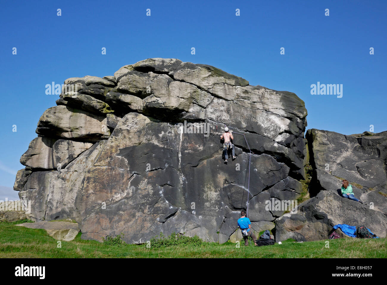 Man rock climbing, Almscliff Crag, near Otley and Harrogate, Yorkshire, UK. Stock Photo