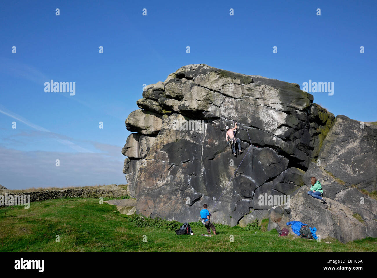 Man rock climbing, Almscliff Crag, near Otley and Harrogate, Yorkshire, UK. Stock Photo