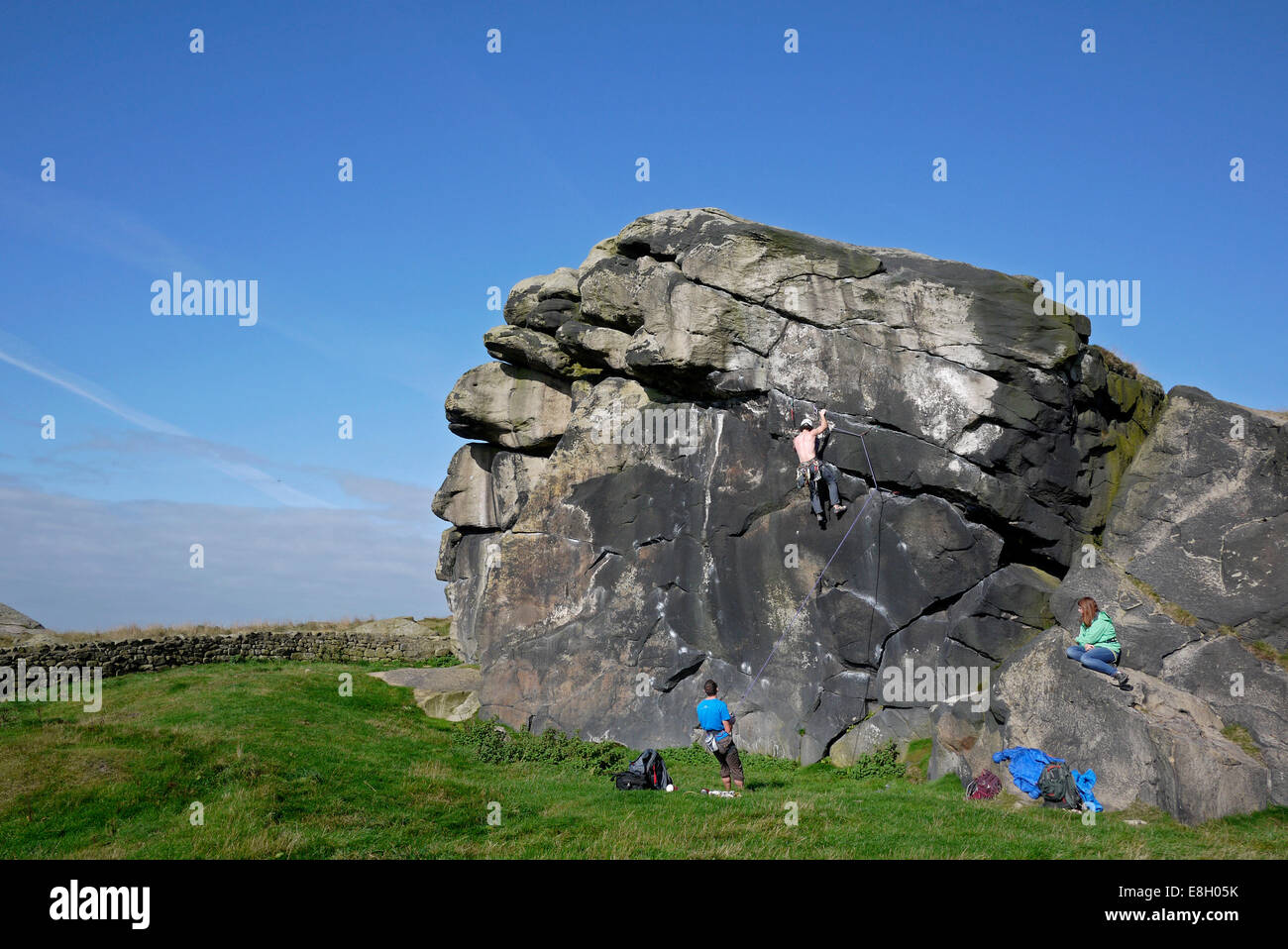 Man rock climbing, Almscliff Crag, near Otley and Harrogate, Yorkshire, UK. Stock Photo