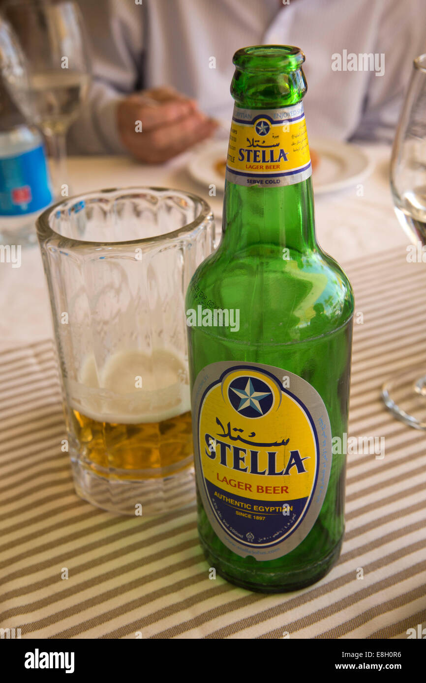 Egypt, Luxor, bottle of Stella Egyptian Lager Beer on table with glass Stock Photo