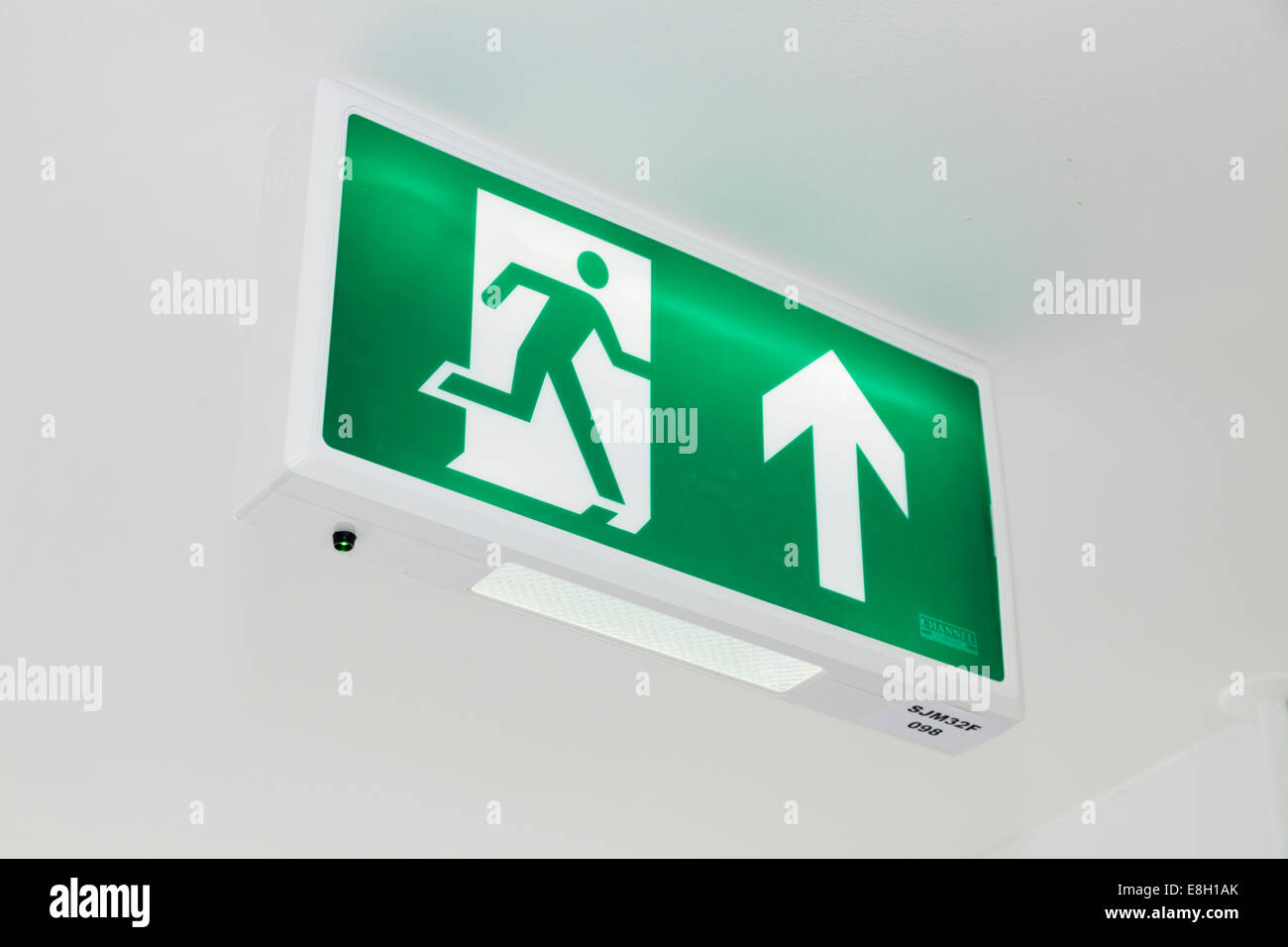 Green fire escape direction sign. Stock Photo