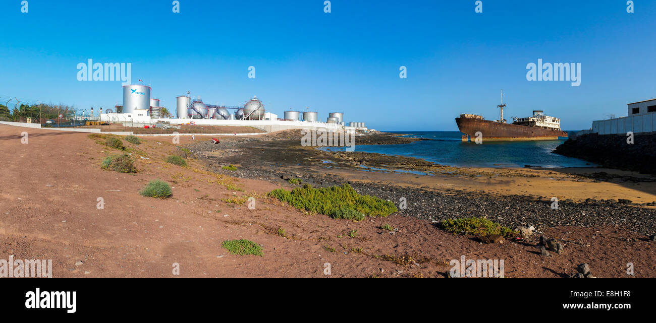Spain, Canary Islands, Lanzarote, Arrecife, Punta Chica, Ship wreck Telamon, Industrial plant of Disa company in the background Stock Photo
