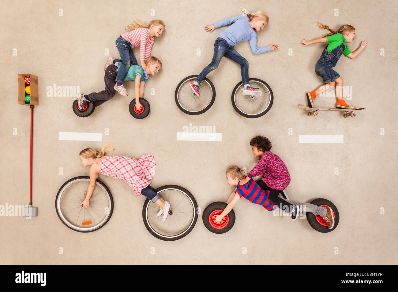 Children biking and skating on road Stock Photo Alamy