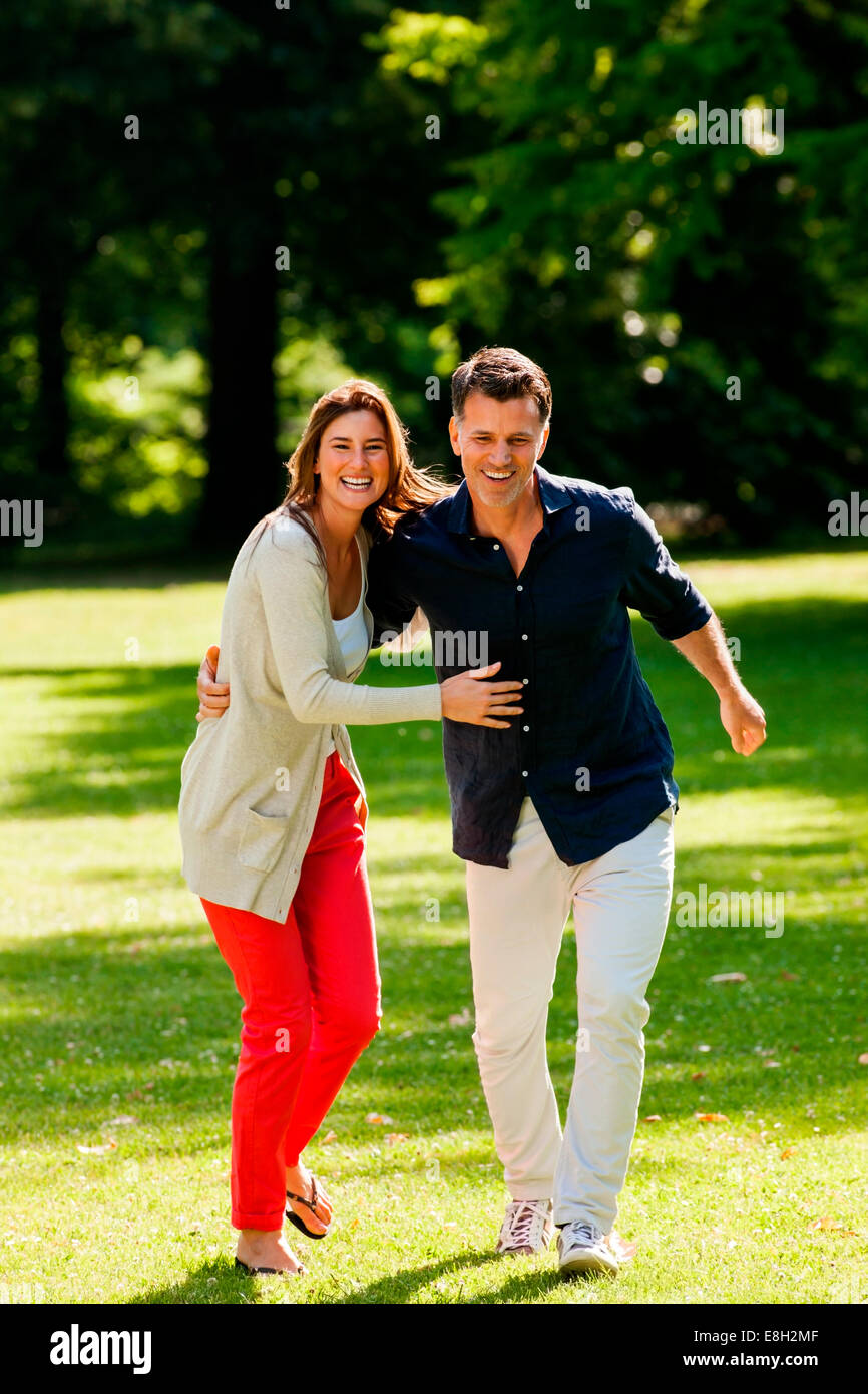 Couple having fun in a park Stock Photo - Alamy