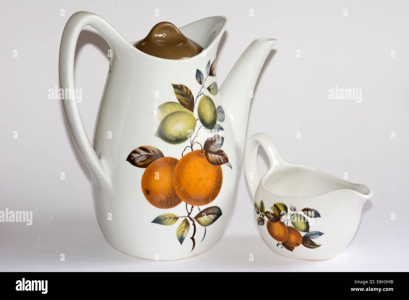Midwinter oranges and lemons coffee pot and milk jug Stock Photo