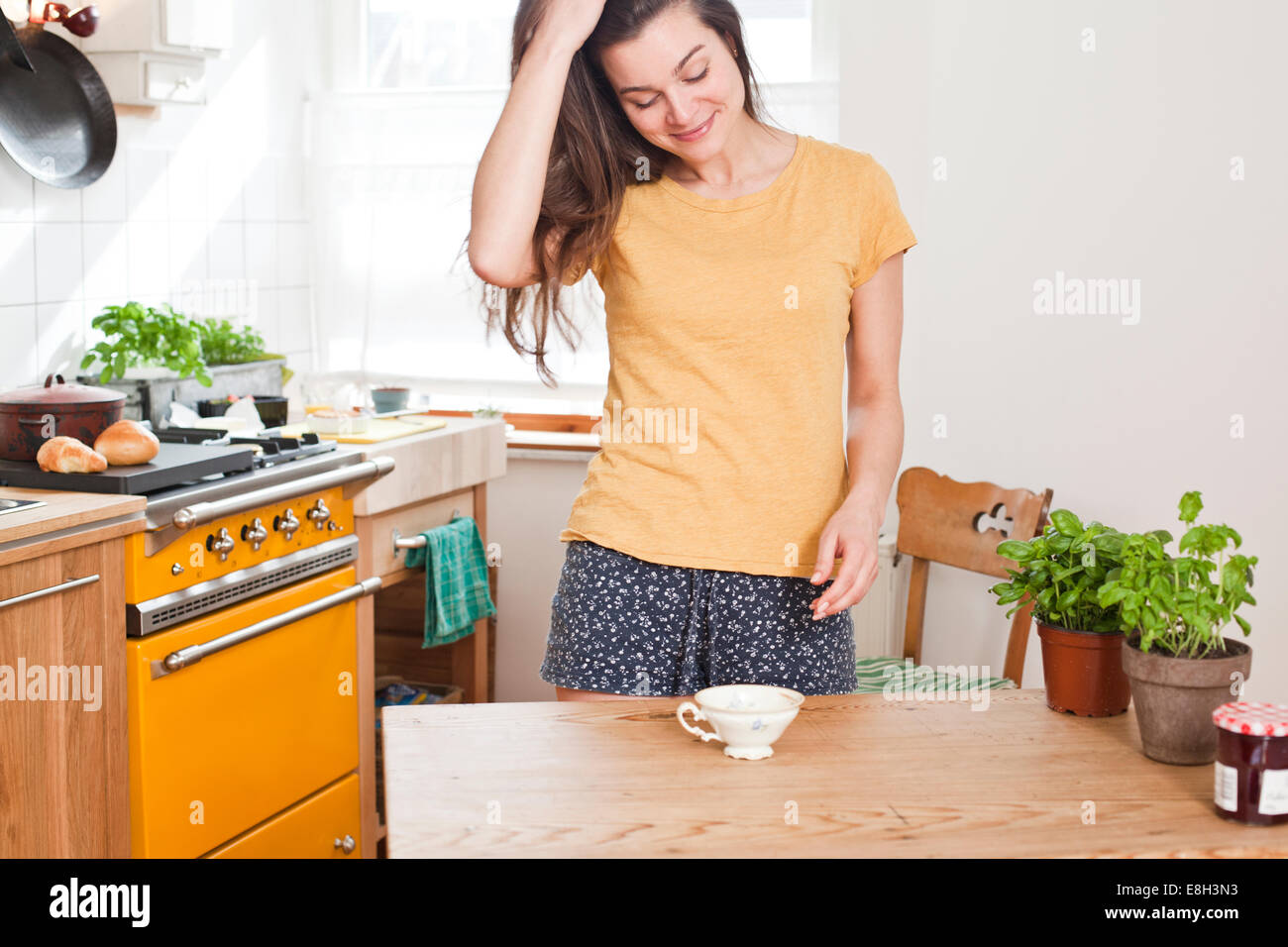 Woman standing her kitchen hi-res stock photography and images - Alamy