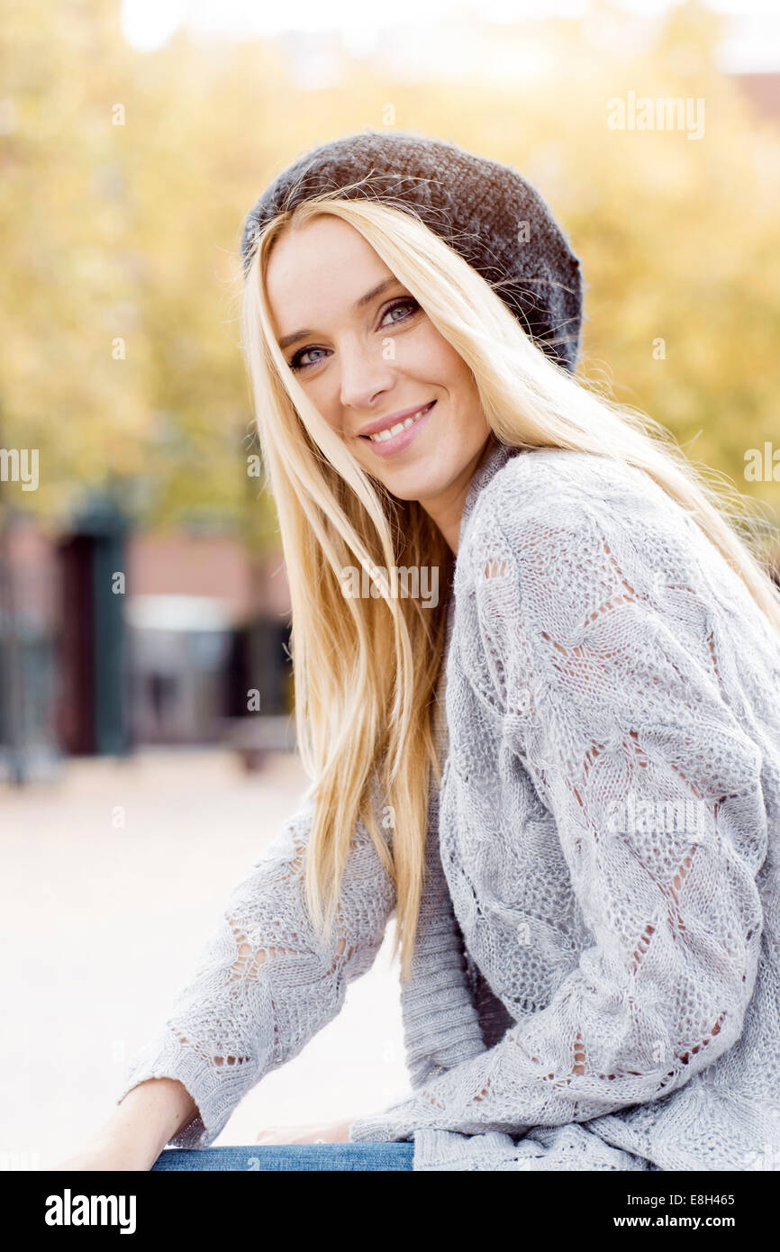 Portrait of smiling young woman wearing wooly hat and cardigan Stock ...
