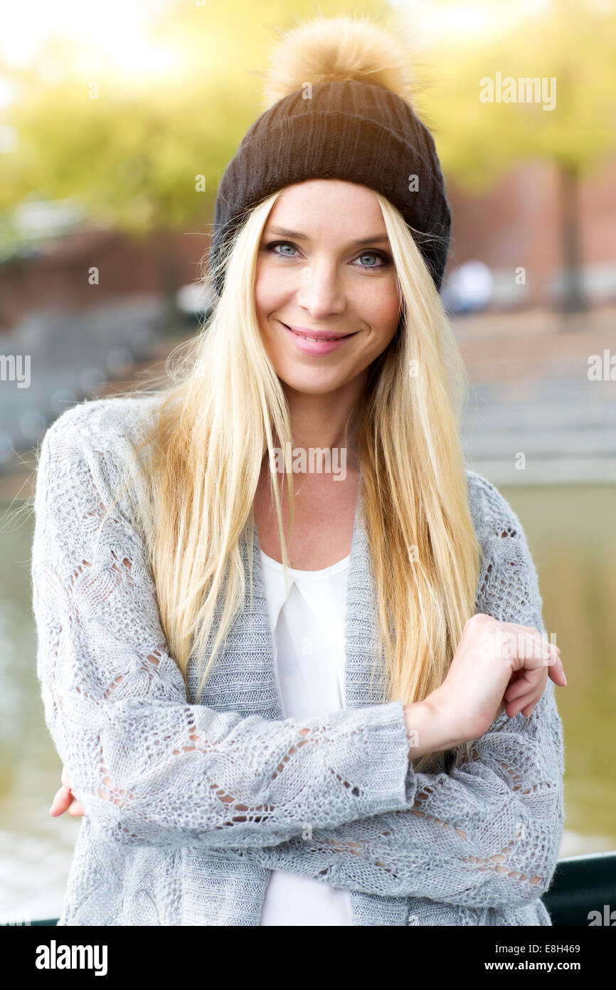 Portrait Of Smiling Young Woman Wearing Bobble Hat And Cardigan