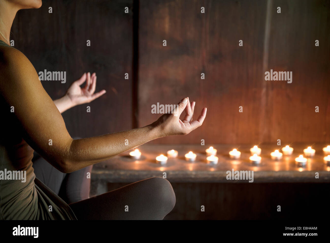 Woman meditating in wooden house Stock Photo