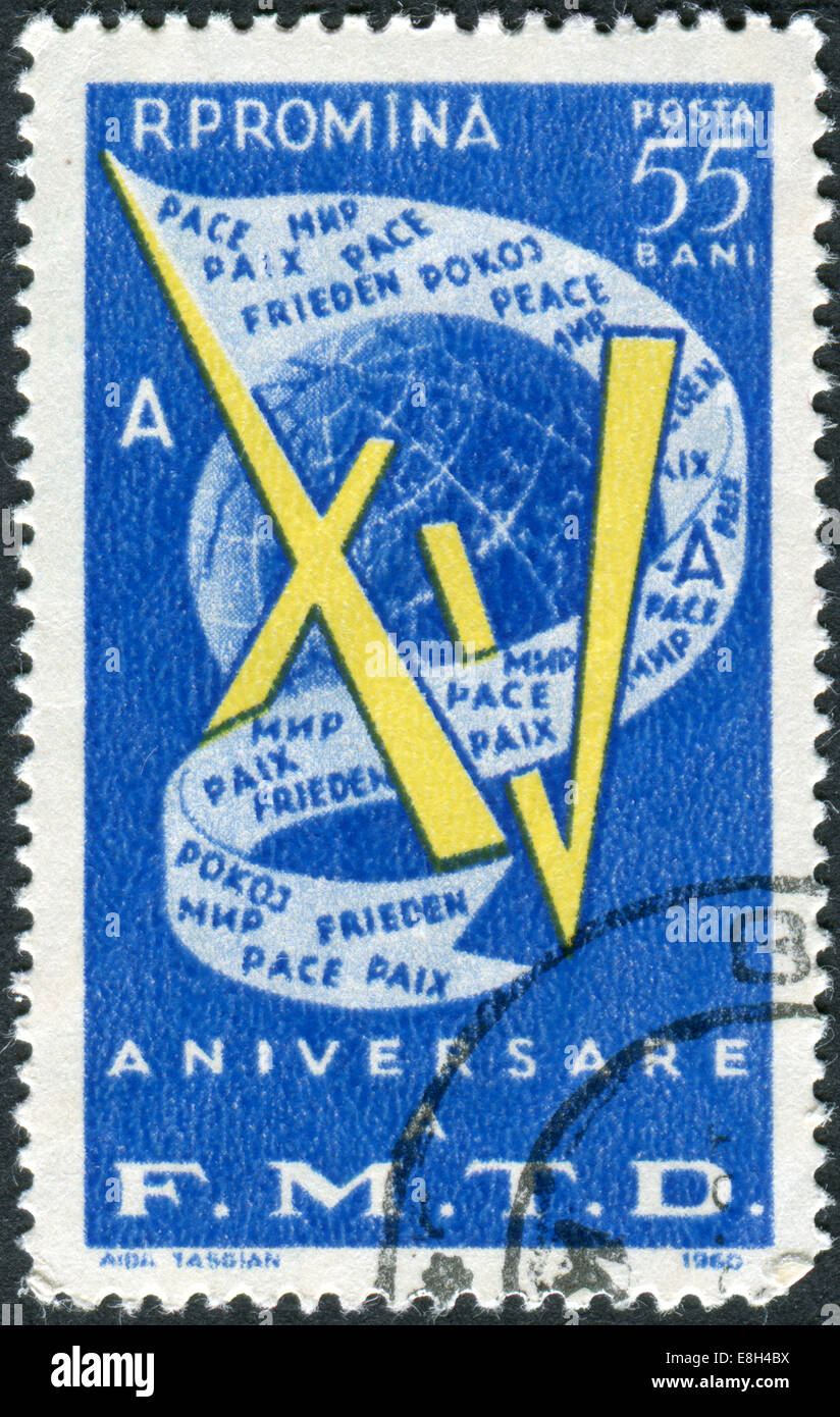 Stamp printed in Romania, Fifteenth Anniversary of World Federation of Democratic Youth, shows Globe and flag with inscription Stock Photo