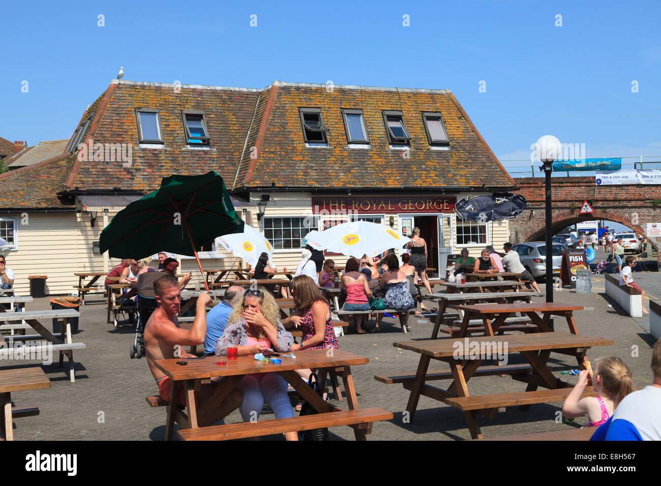 People enjoying the summer sunshine outside the Royal George Pub near the harbour at Folkestone. Stock Photo