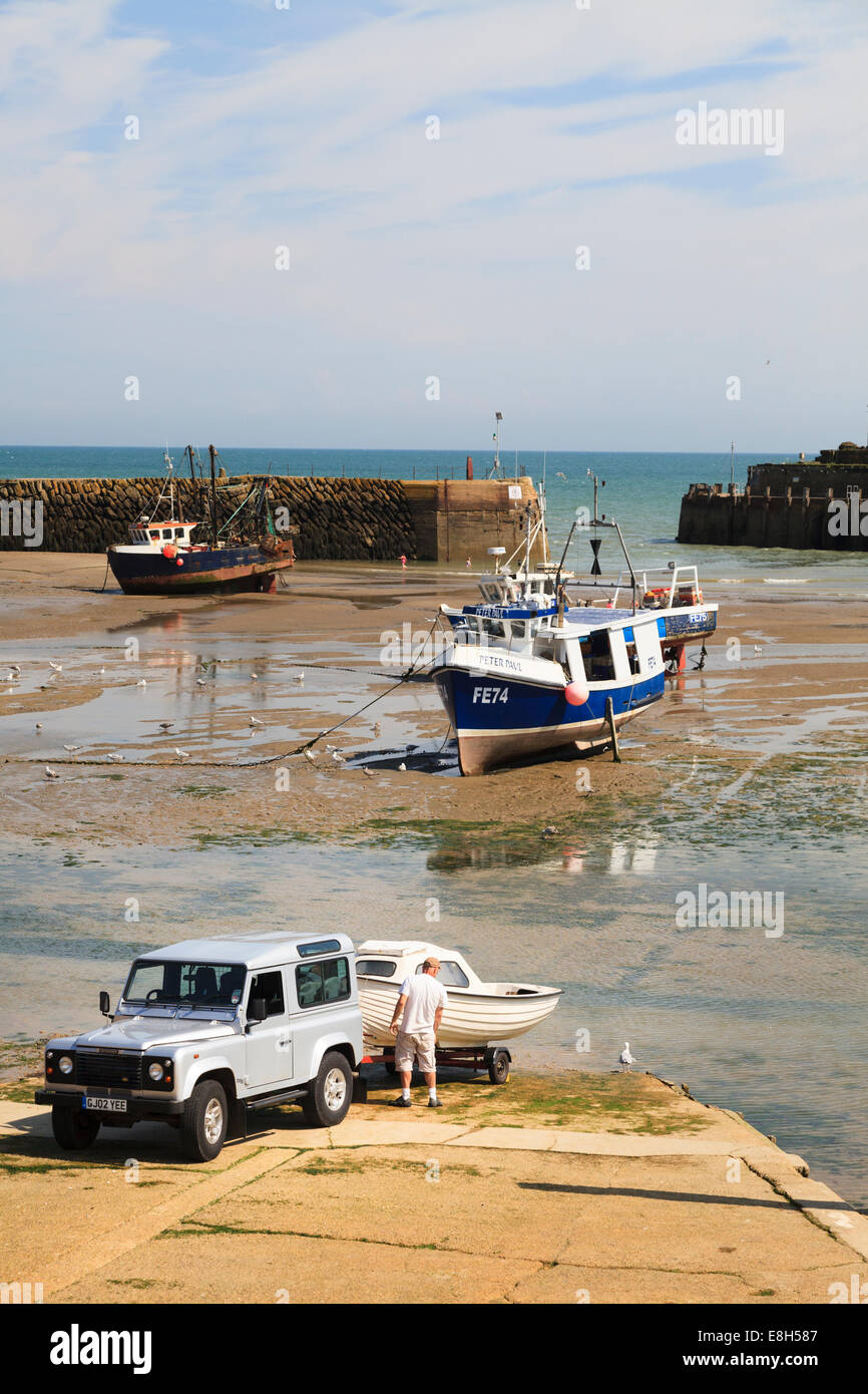 Hitching up a small boat to a trailer on the slipway at Folkestone Harbour. Stock Photo