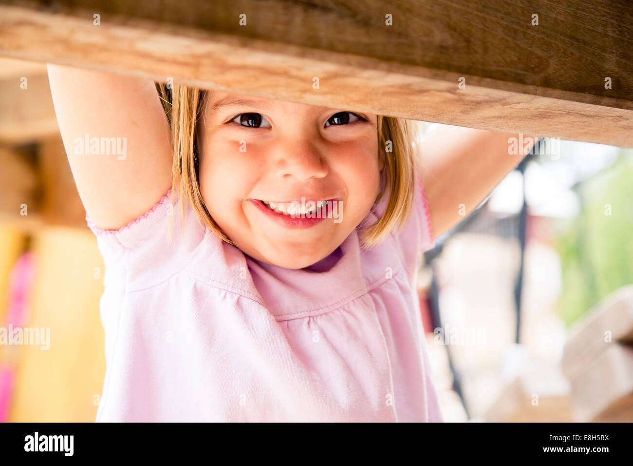 Happy little girl on playground Stock Photo - Alamy