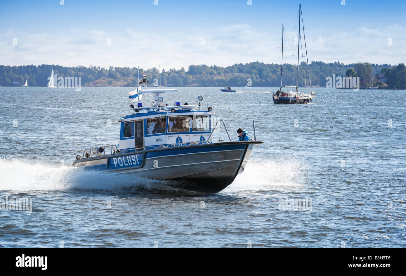 HELSINKI, FINLAND - SEPTEMBER 13, 2014: fast water police motor boat with policemen  sails in harbor of Helsinki Stock Photo