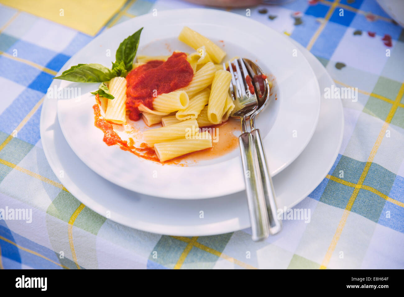 Plate with pasta on garden table Stock Photo