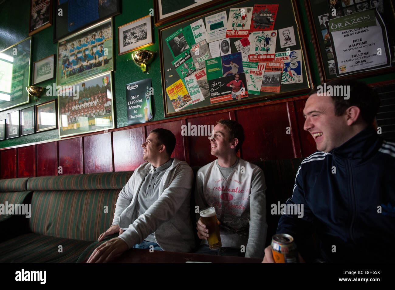 Celtic Football Club fans gather in The Brazen Head bar to watch a Celtic football game on TV, in Glasgow, Scotland Stock Photo