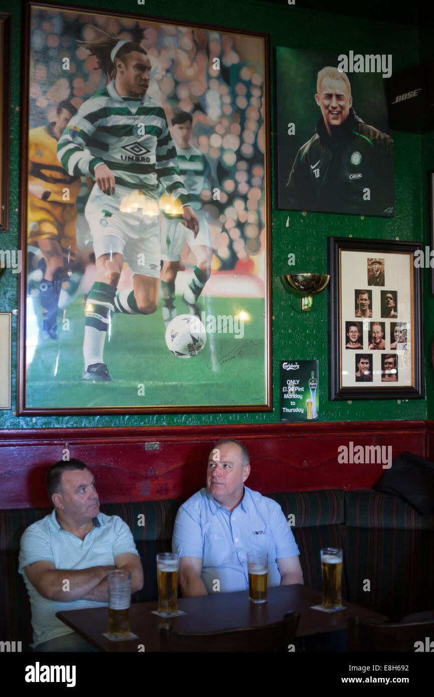 Celtic Football Club fans gather in The Brazen Head bar to watch a Celtic football game on TV, in Glasgow, Scotland Stock Photo