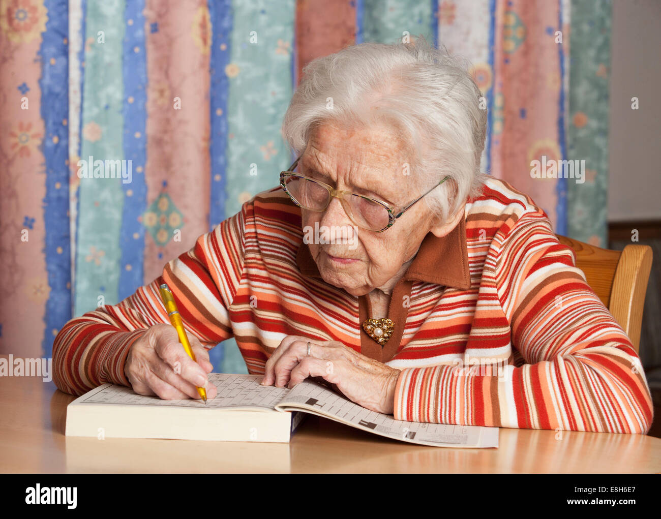 Portrait of senior woman with crossword puzzle Stock Photo