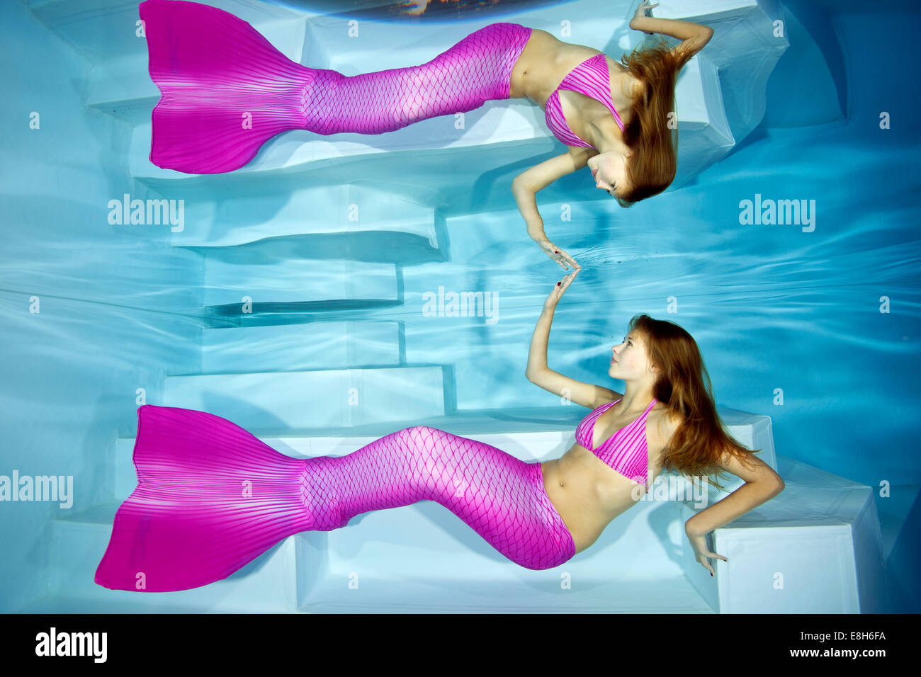 Mermaid girl watching her reflection under water Stock Photo
