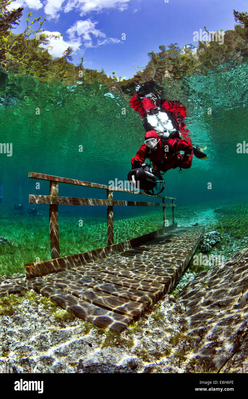 Austria, Styria, Tragoess, lake Gruener See, diver swimming over a bridge Stock Photo