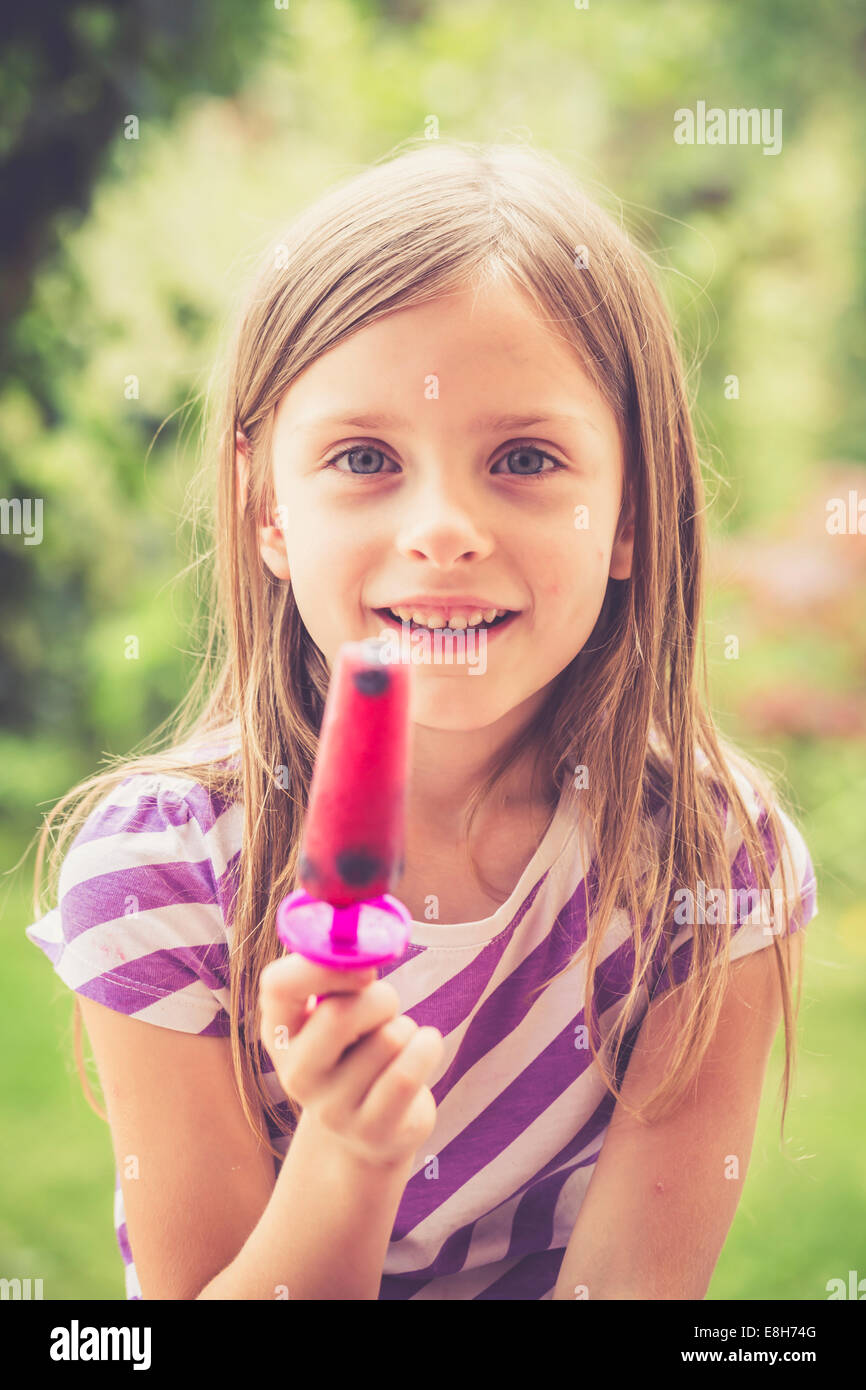 Portrait of little girl with popsicle in the garden Stock Photo - Alamy