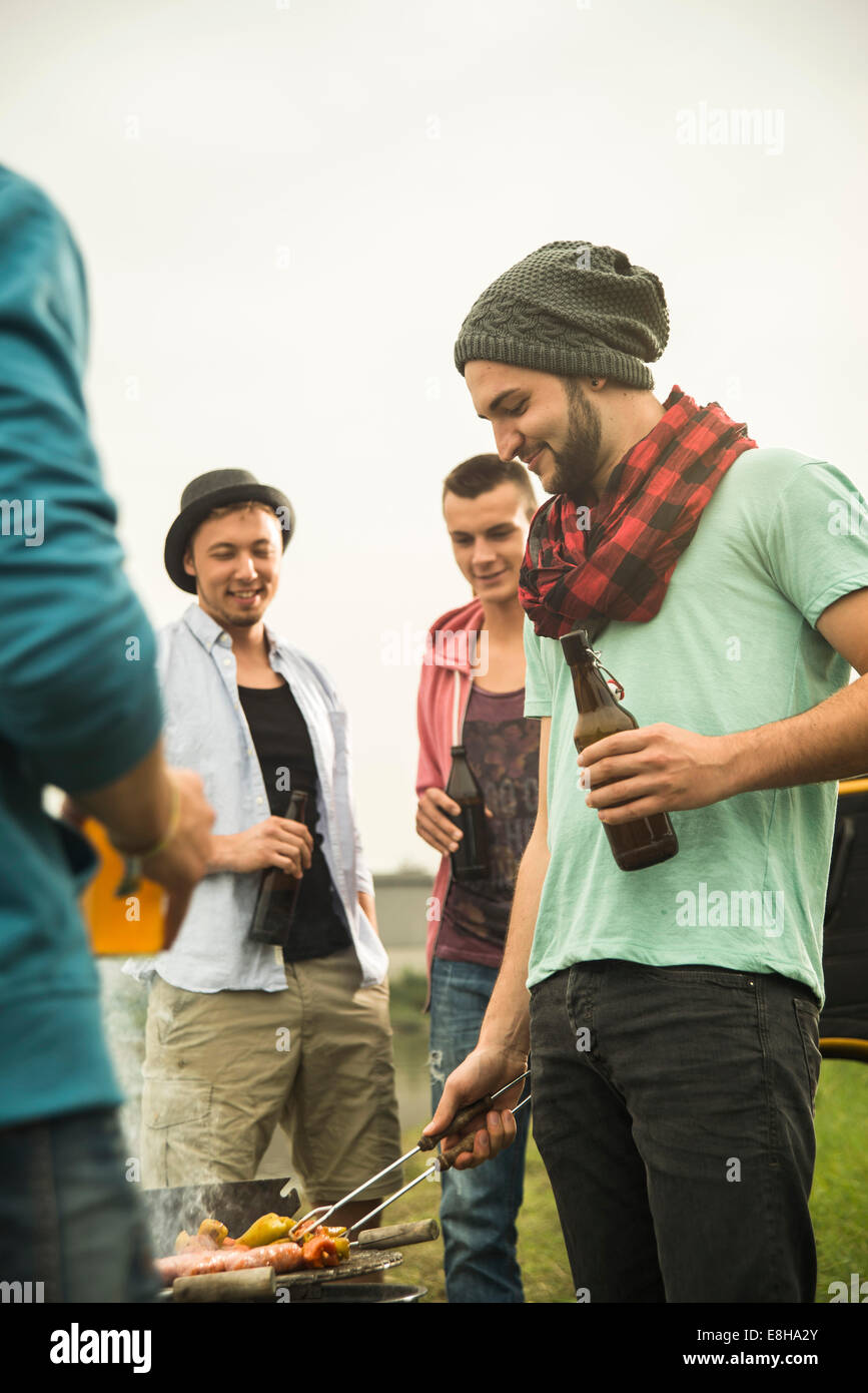 Group of friends drinking beer and having a barbecue Stock Photo - Alamy