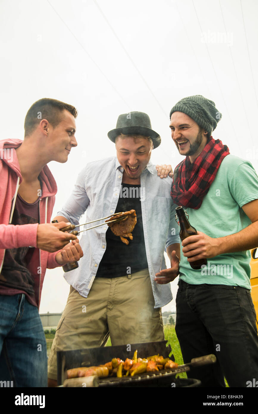 Group of friends drinking beer and having a barbecue Stock Photo - Alamy
