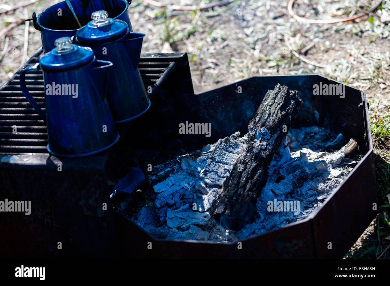 Pots boiling water on camping fire pit with wood Stock Photo Alamy