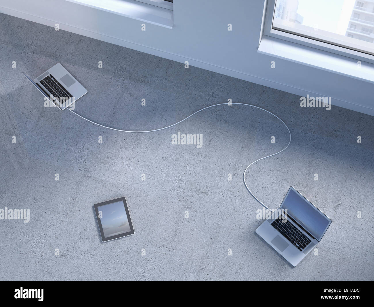 Two wired laptops and a digital tablet on concrete floor, 3D Rendering ...