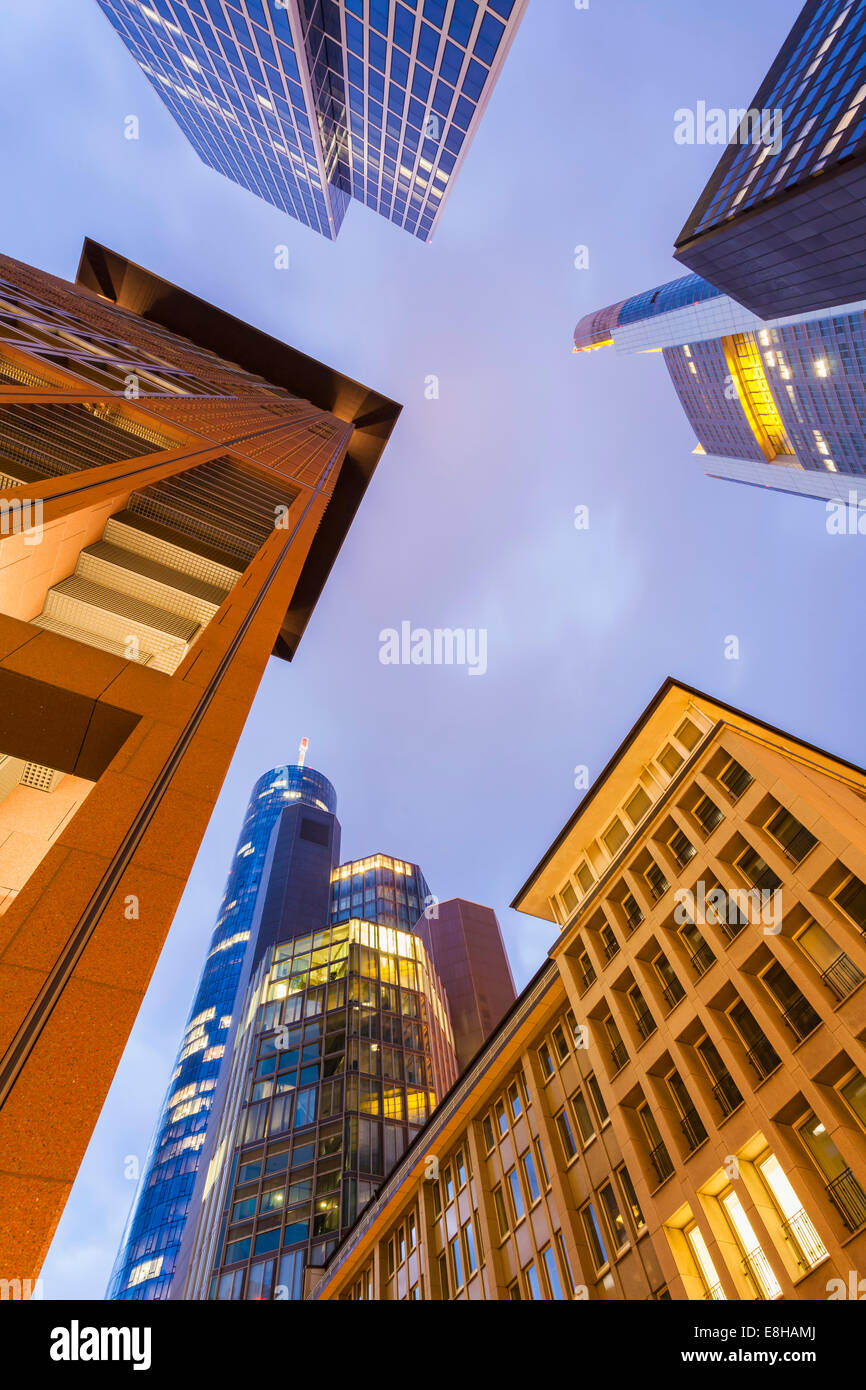 Germany, Hesse, Frankfurt, view to facades of modern office buildings from below at twilight Stock Photo