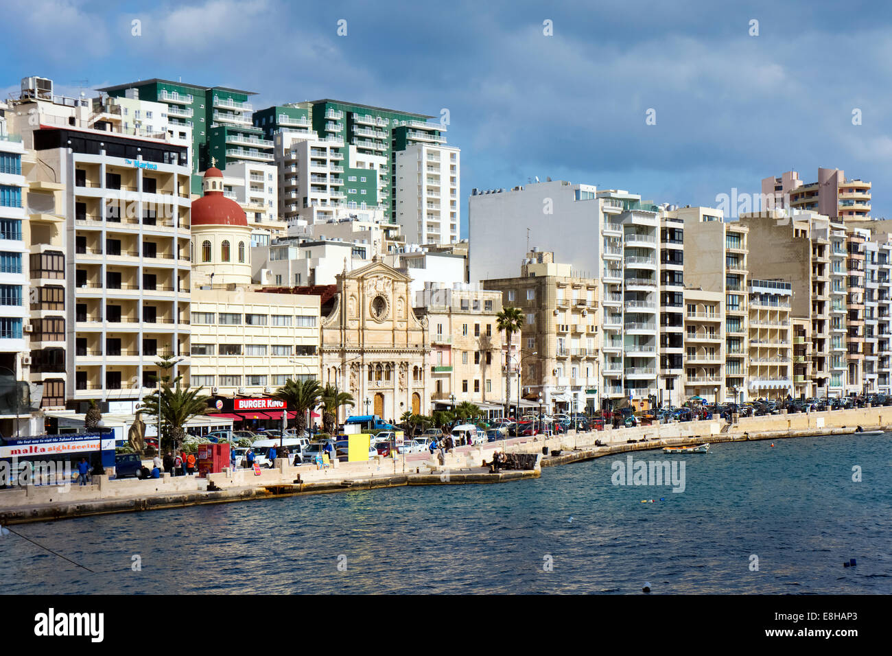 Malta, Sliema, historical building between new buildings at waterfront Stock Photo