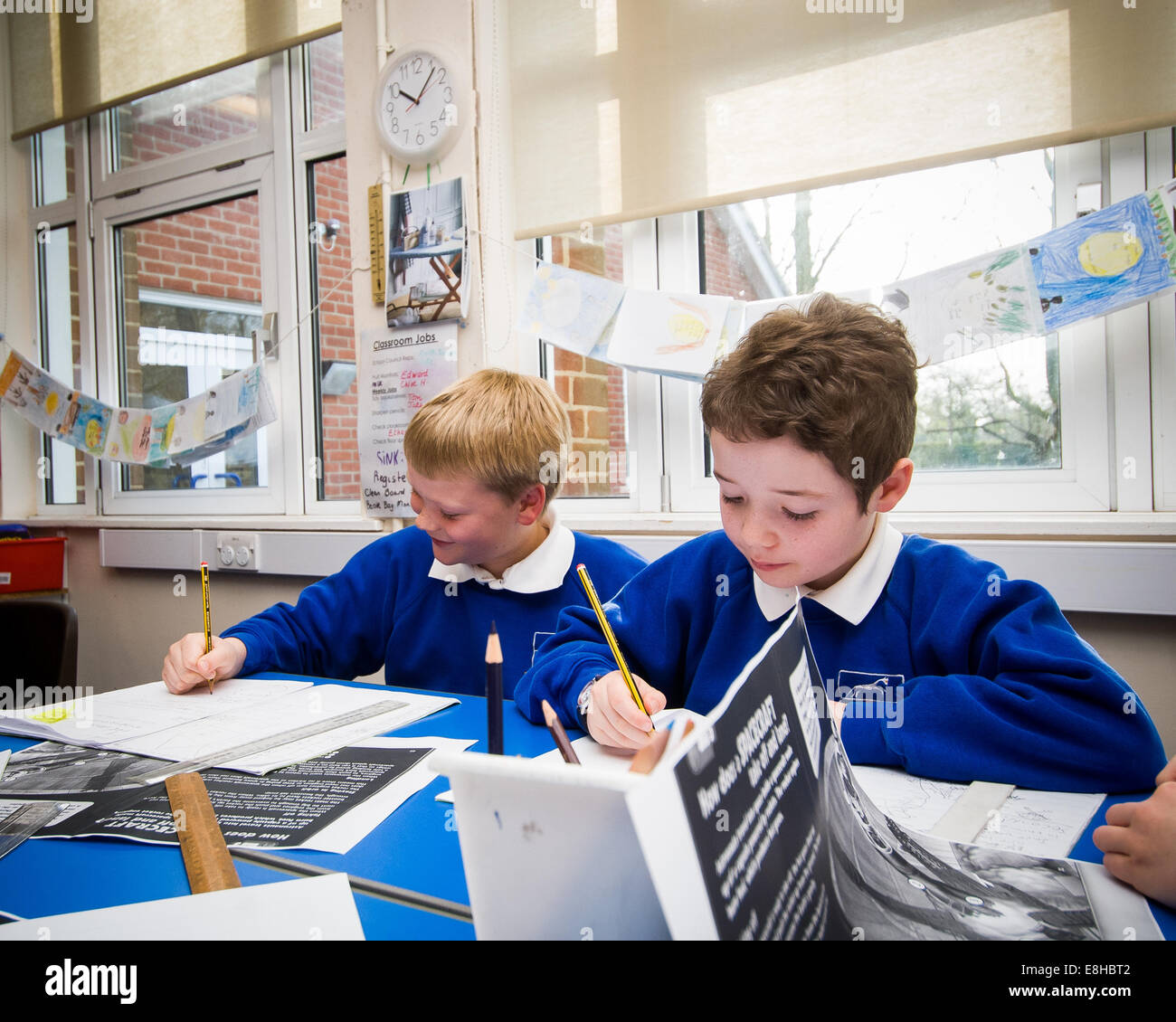 2 boys working hard in Primary school classroom in Oxfordshire,UK Stock Photo
