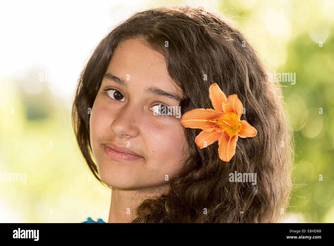 Teen girl with curly dark hair on nature Stock Photo - Alamy
