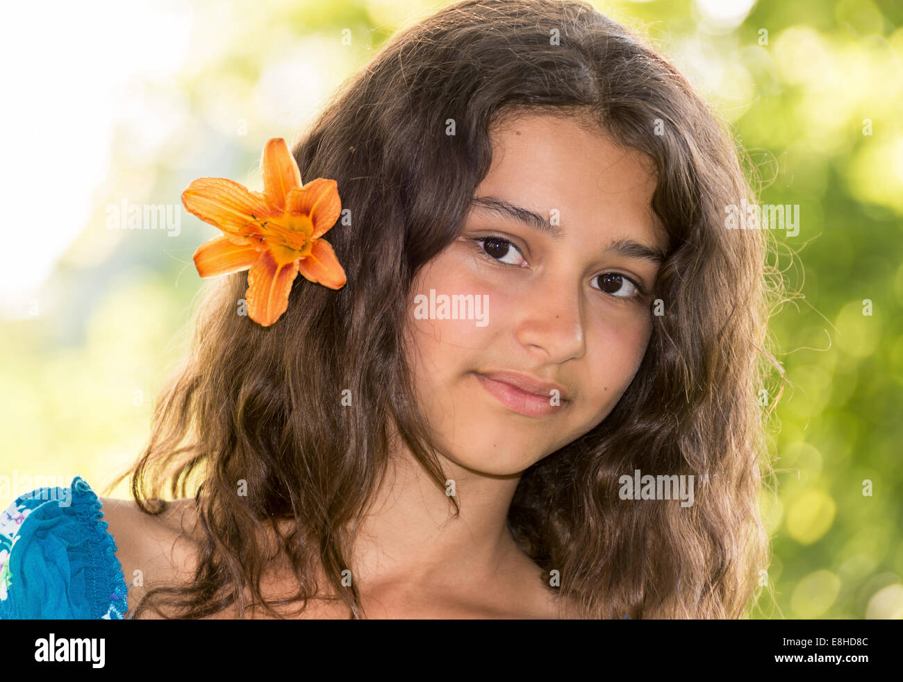 Teen girl with curly dark hair on nature Stock Photo - Alamy