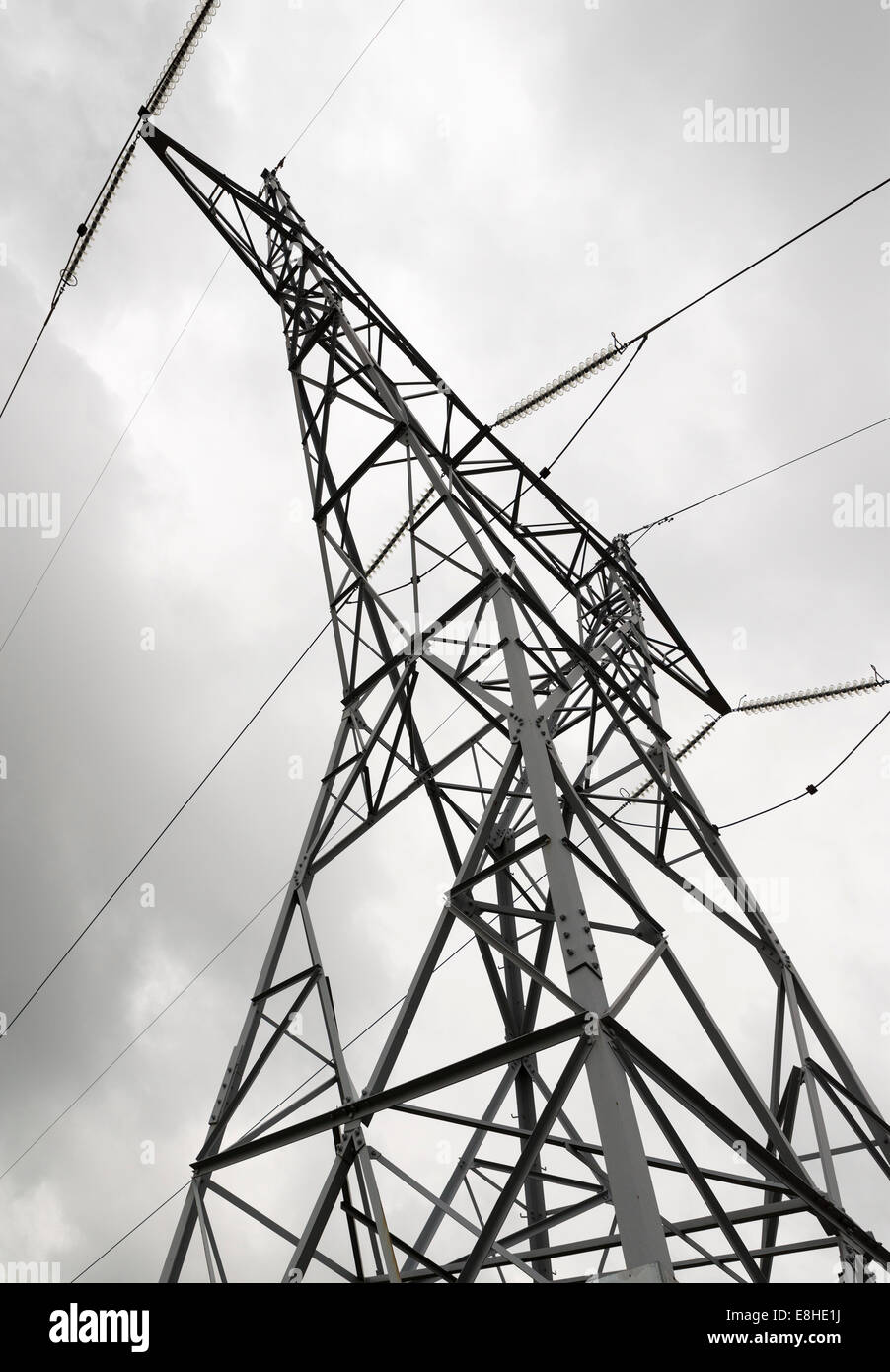 Power lines and electric pylon against cloudy sky Stock Photo - Alamy
