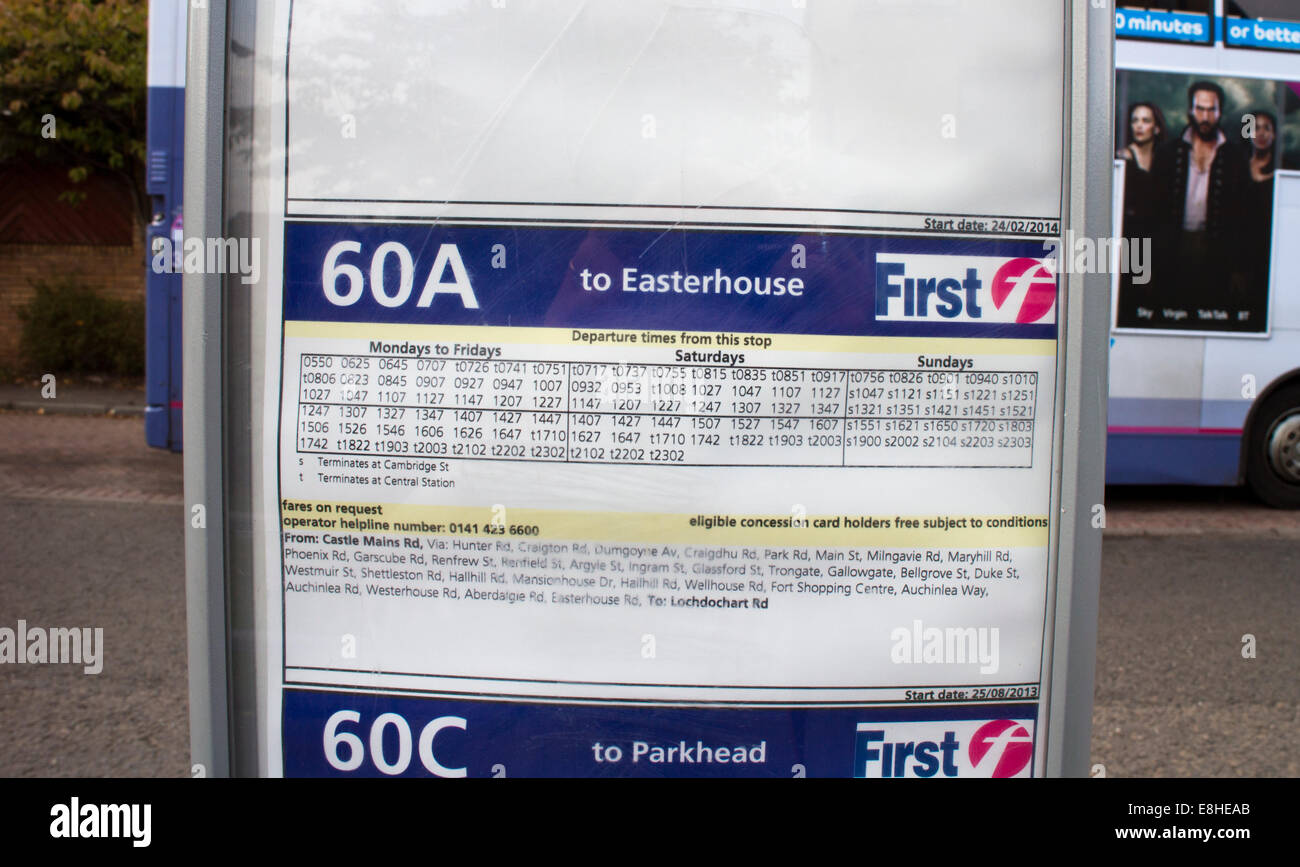 Glasgow first bus timetable with a blurred bus in the background stock