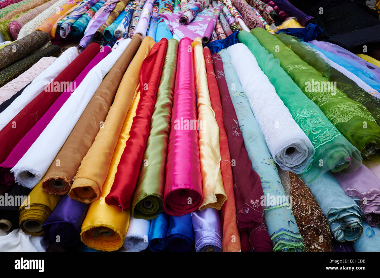 Rolls of fabric for sale in East Street Market, London, UK Stock Photo