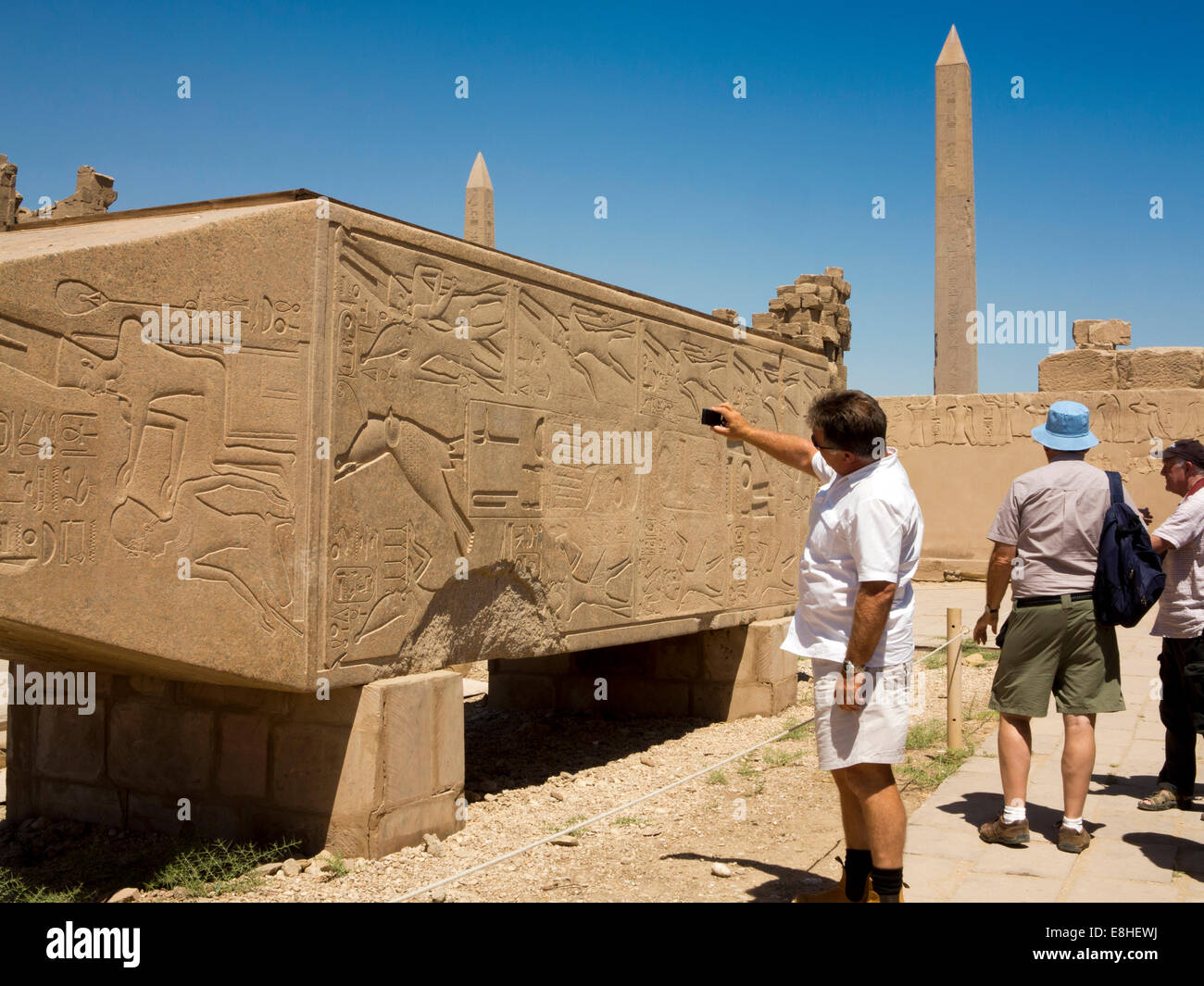 Egypt, Luxor, Karnak Temple, tourist taking picture of Hapshetsut granite obelisk lying horizontal Stock Photo