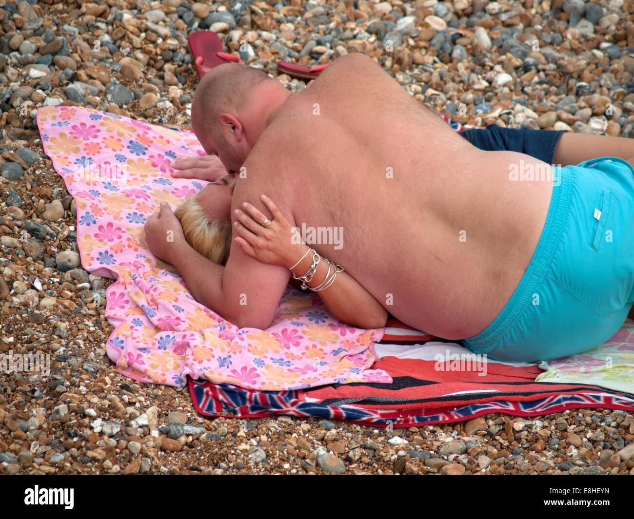 A passionate kiss on the beach at Brighton Stock Photo