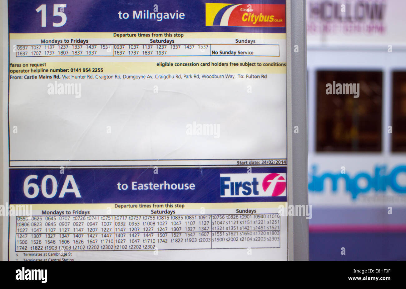 Bus timetable with blurred bus in background Stock Photo