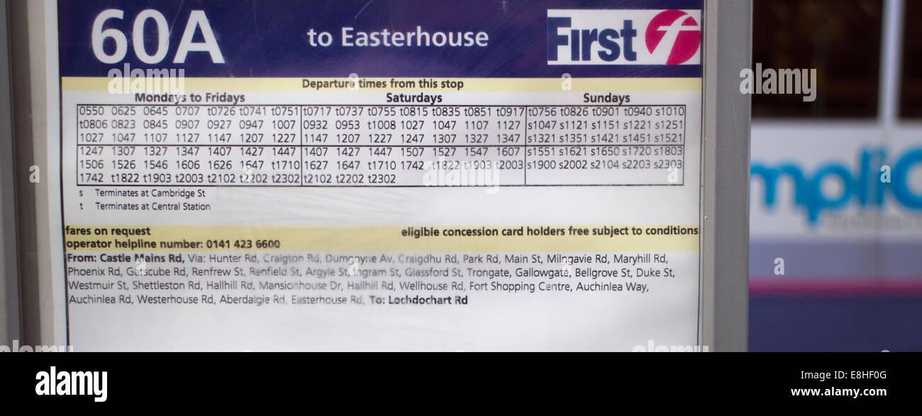 Glasgow First Bus timetable with a blurred bus in the background Stock Photo