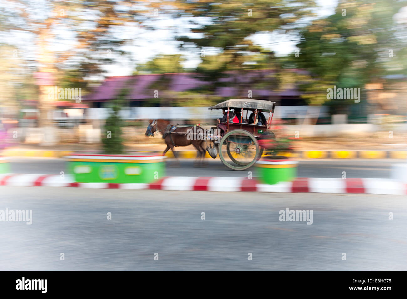 Two wheeled cart taxi and passengers being pulled by a pony, Bagon, Burma, Myanmar Stock Photo