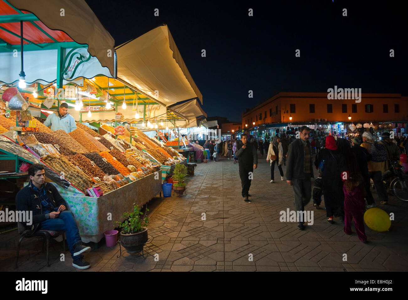 Horizontal view of the busy temporary food stalls set up in Place Jemaa el Fna (Djemaa el Fnaa) in Marrakech at night. Stock Photo