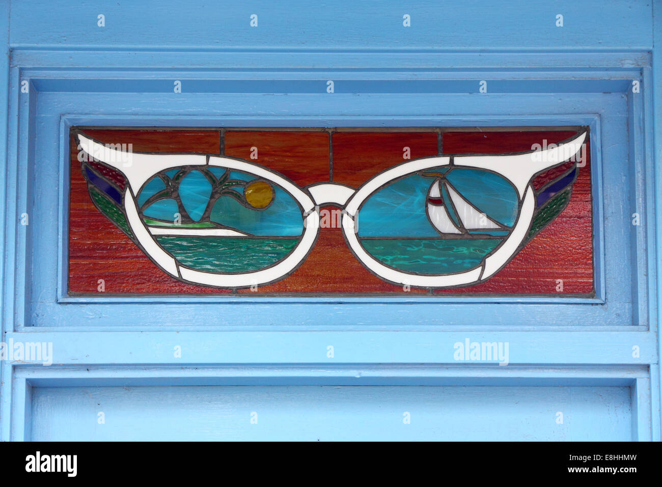 Spectacle-themed stained glass window in the doorway of DP Opticians in Ballater, Scotland Stock Photo