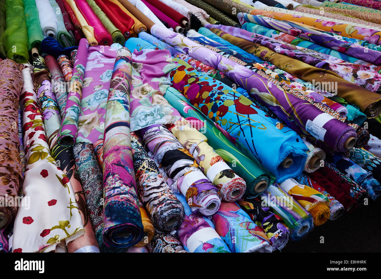 Rolls of fabric for sale in East Street Market, London, UK Stock Photo