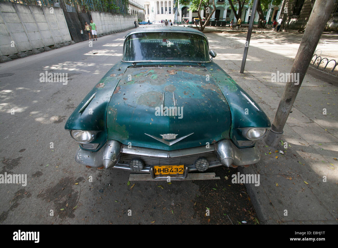 Weathered turquoise 1950's Cadillac with bullet bumper and wrap-around windshield parked on the street in Havana, Cuba. Stock Photo