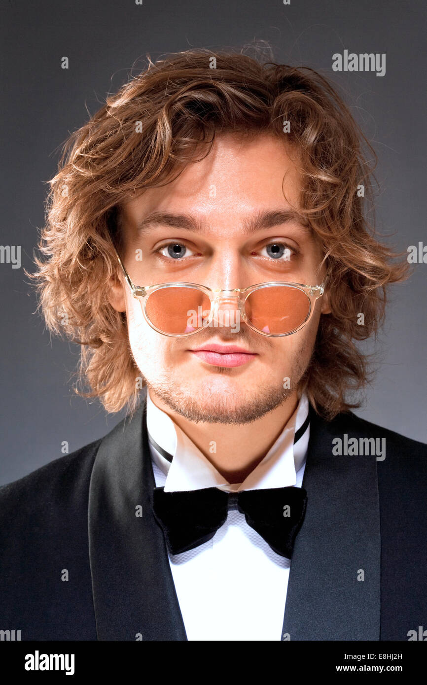Portrait of a Young Man with Glasses in Tuxedo Stock Photo